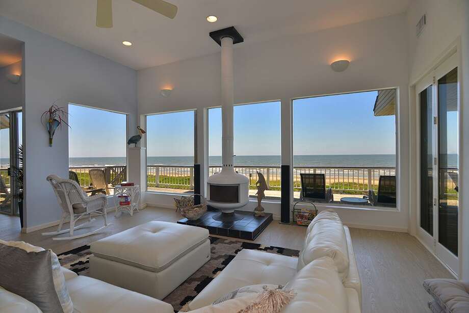 Spacious living room with minimalist design and large glass doors.